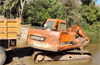 Beltangady: Police raid illegal sand mining site, seize tipper and Hitachi machine