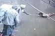 On camera, child jolted by live wire on wet street, saved by elderly man
